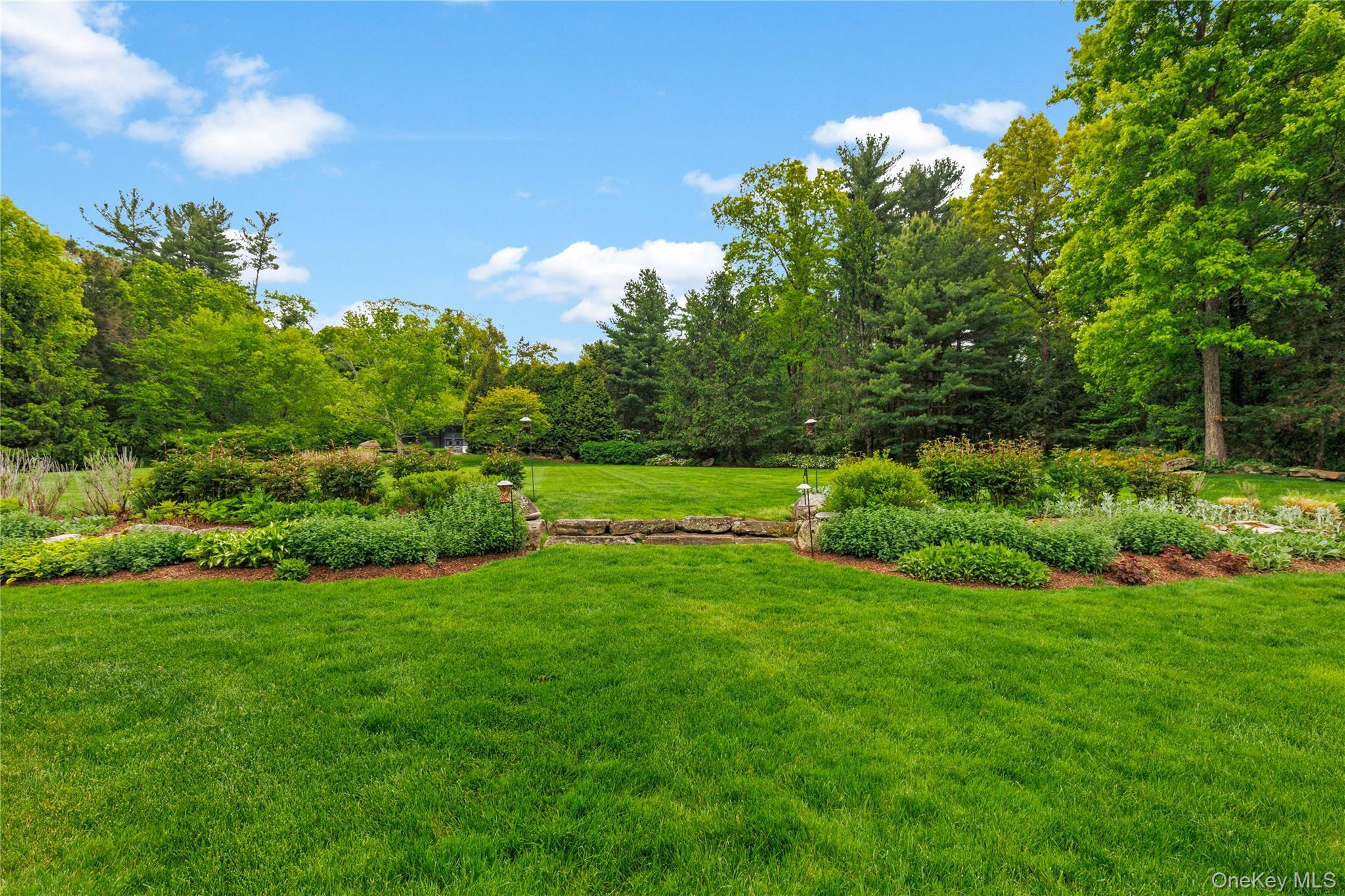 63 Old Mill River Road Pound Ridge, NY 10576 - Photo 35 of 47 a view of a garden with a tree