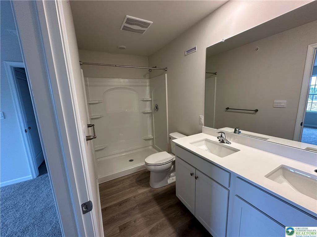 1145 Martin Road Breinigsville, PA 18031 - Photo 26 of 38 Dual vanities complement a bright, functional bathroom with a tub and shower combination.