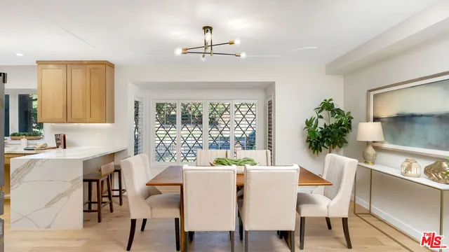 a dining room with furniture window and wooden floor