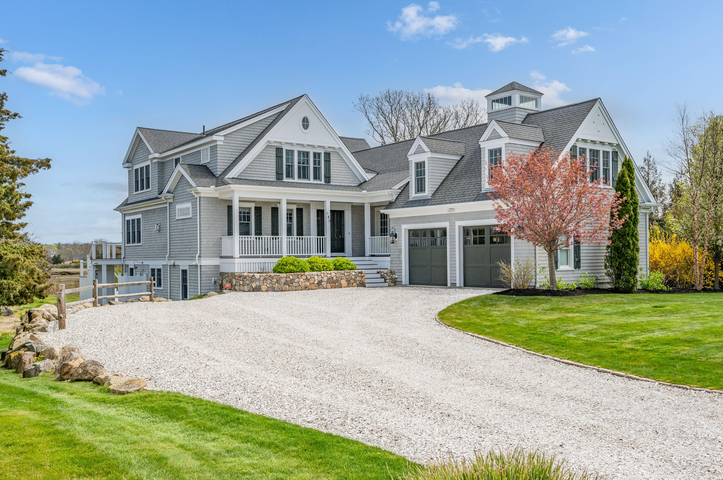 189 Harbor Point Road Barnstable, MA 02675 - Photo 46 of 68 a view of a white house with a big yard and potted plants