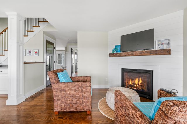 a large bedroom with a large bed a large window and book shelf