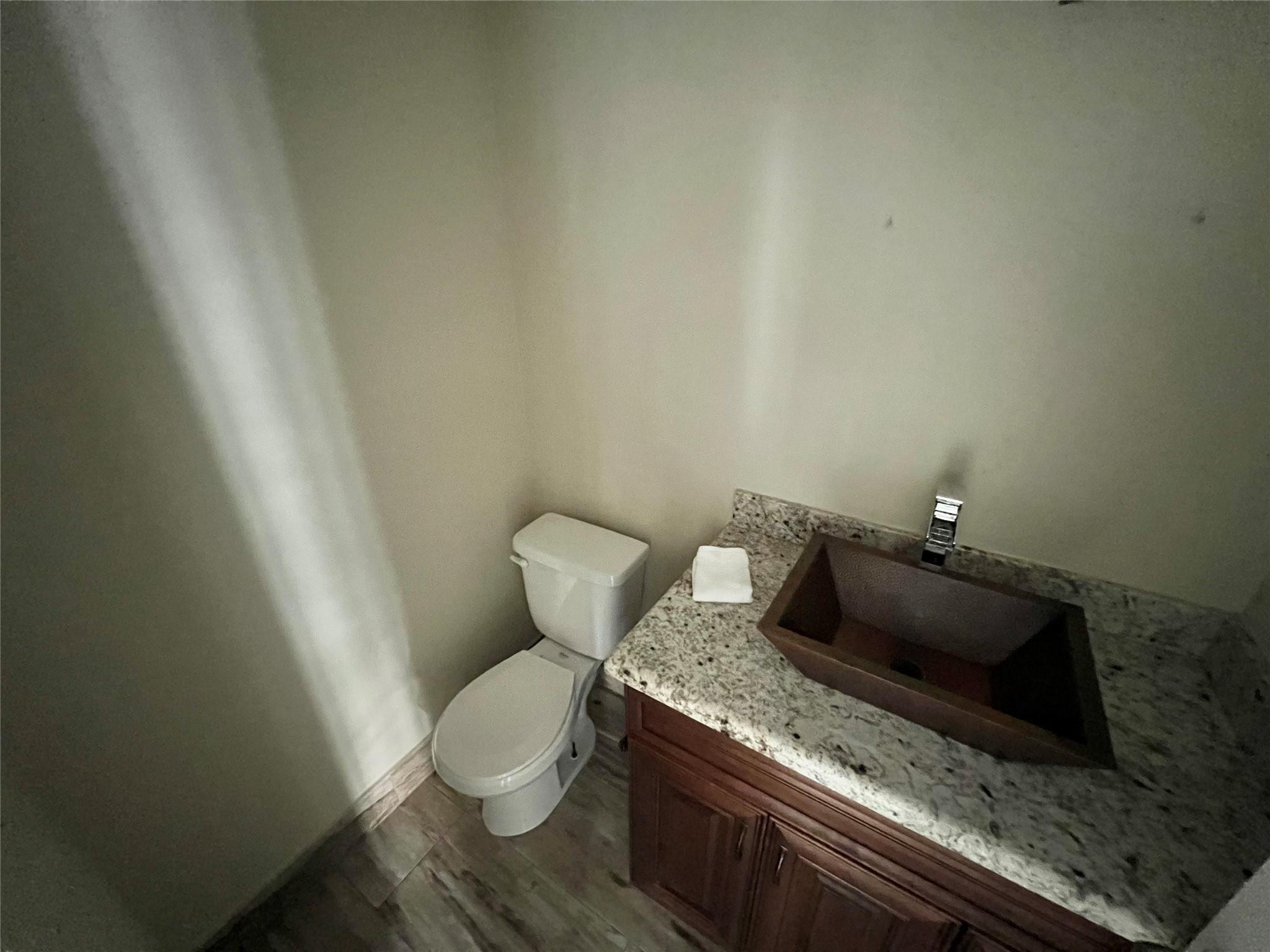 9380 Southwest 61st Way, Unit C Boca Raton, FL 33428 - Photo 16 of 32 a bathroom with a granite countertop toilet and a sink