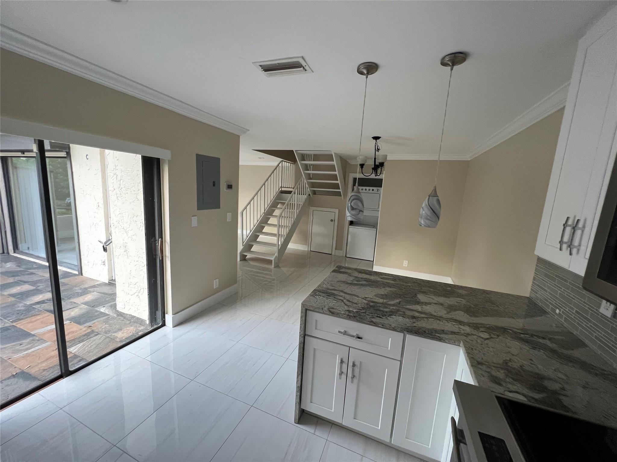 9380 Southwest 61st Way, Unit C Boca Raton, FL 33428 - Photo 3 of 32 a kitchen with granite countertop a sink a counter top space and cabinets