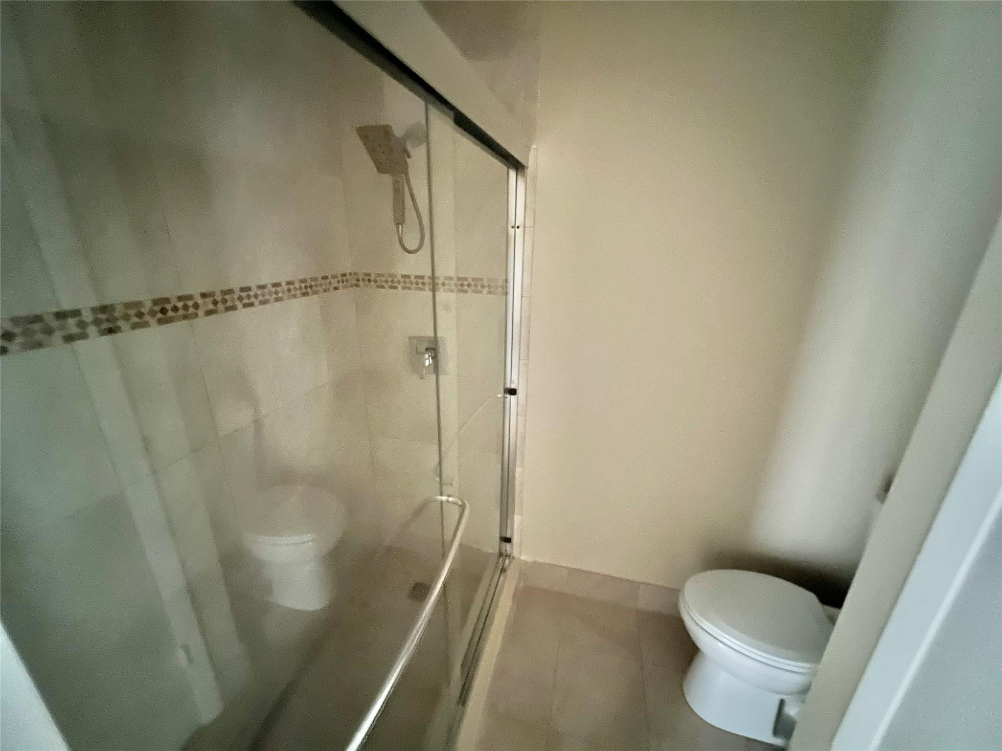 9380 Southwest 61st Way, Unit C Boca Raton, FL 33428 - Photo 8 of 32 a bathroom with a shower and toilet