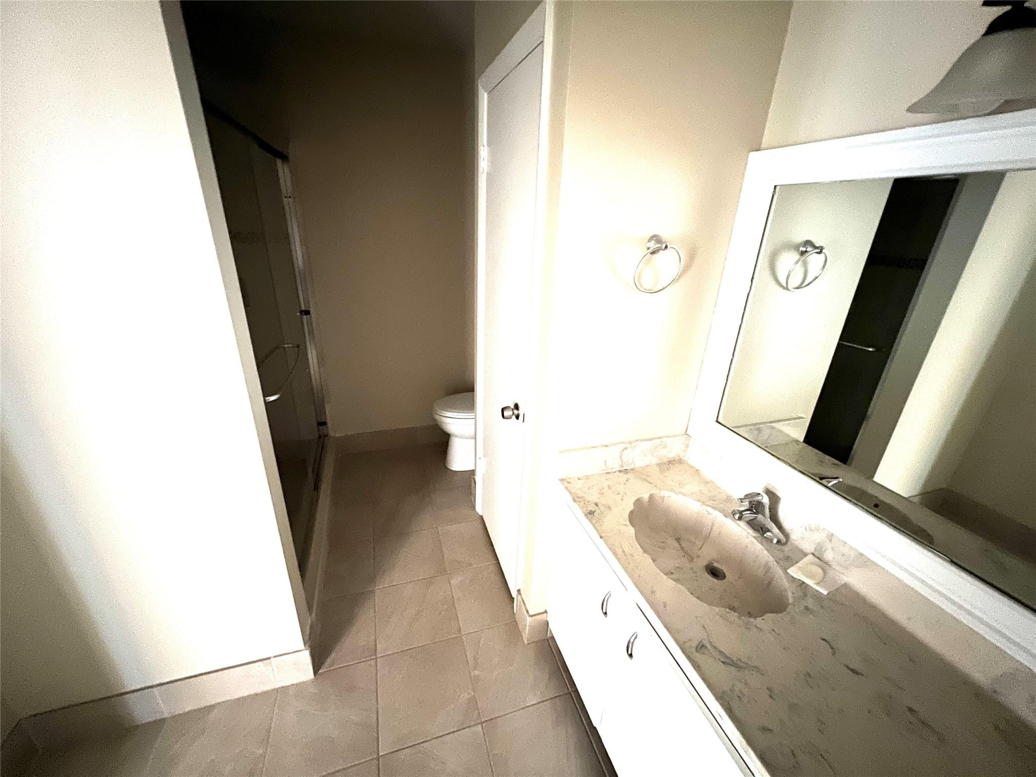 9380 Southwest 61st Way, Unit C Boca Raton, FL 33428 - Photo 9 of 32 a bathroom with a sink and a mirror