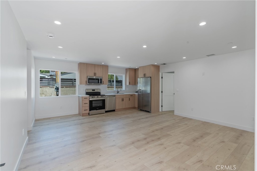 7437 Ranchito Avenue Van Nuys, CA 91405 - Photo 2 of 9 a kitchen with stainless steel appliances a refrigerator and a stove top oven