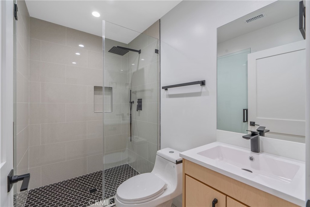 7437 Ranchito Avenue Van Nuys, CA 91405 - Photo 7 of 9 a bathroom with a sink toilet and shower