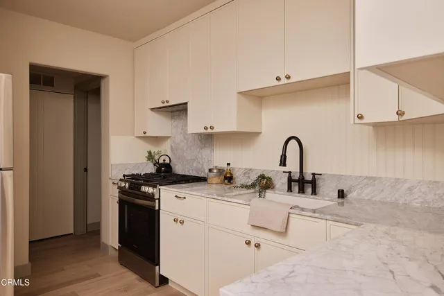a view of a balcony with furniture and floor to ceiling window