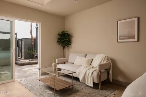 a view of a house with a yard and potted plants