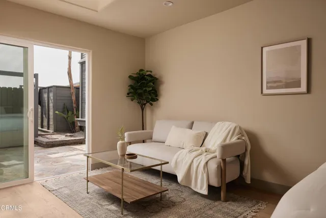 a view of a house with a yard and potted plants