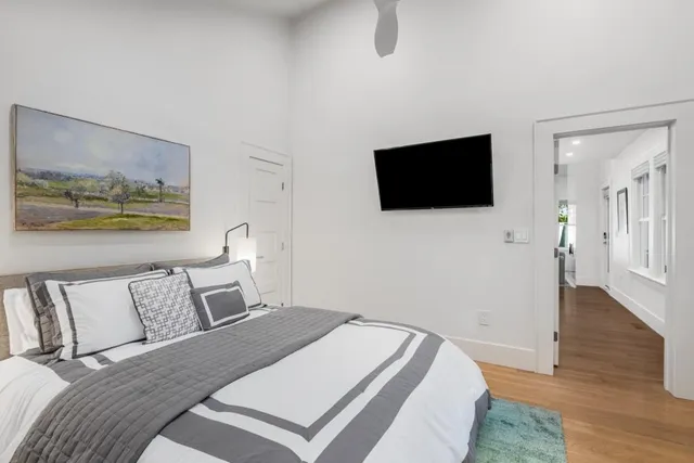 a bedroom with a bed and a flat screen tv