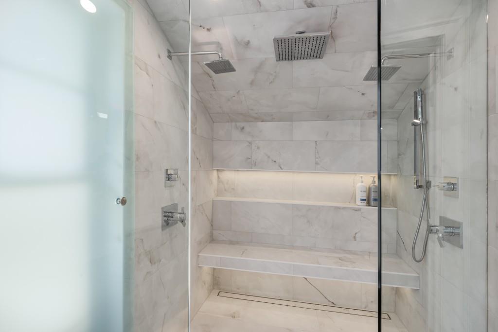 413 8th Street Northeast, Unit A Atlanta, GA 30309 - Photo 23 of 31 a bathroom with a glass shower door