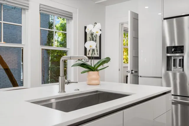 a kitchen with a sink a counter top space and a window