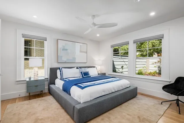 a bedroom with a large bed couch and a window