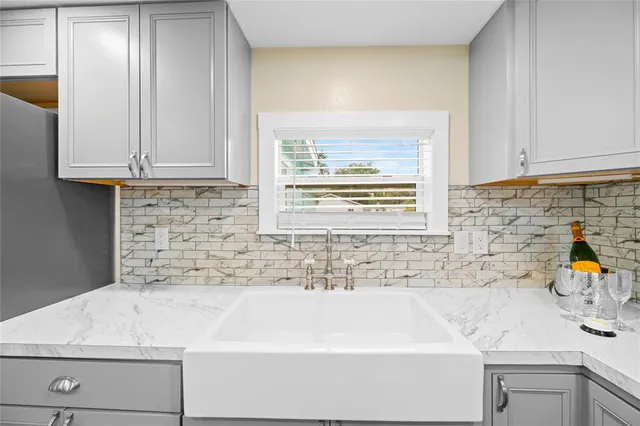 a view of kitchen with stainless steel appliances granite countertop a refrigerator and a sink