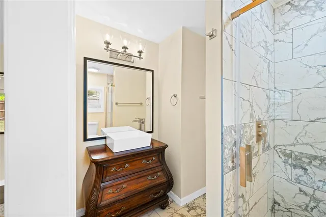 a view of a hallway with wooden floor and a workspace