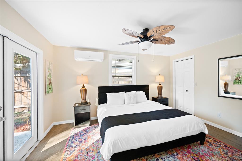 245 South Rhodes Street Mount Dora, FL 32757 - Photo 18 of 64 a bedroom with a bed a dresser and a window