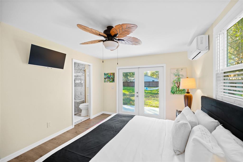 245 South Rhodes Street Mount Dora, FL 32757 - Photo 19 of 64 a bedroom with a bed and a window