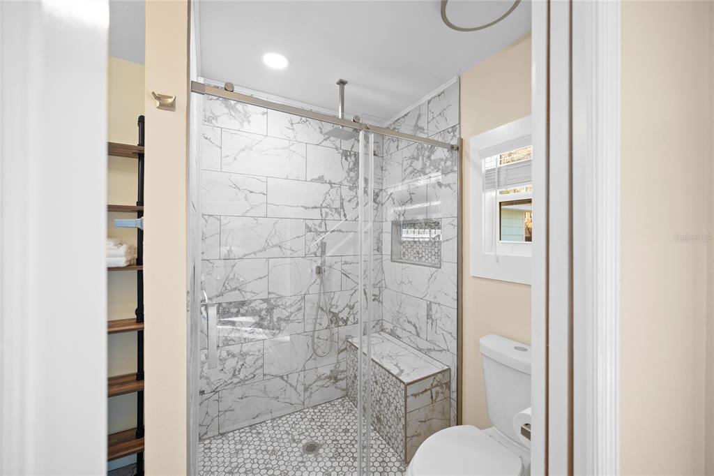 245 South Rhodes Street Mount Dora, FL 32757 - Photo 20 of 64 a bathroom with a shower toilet and sink