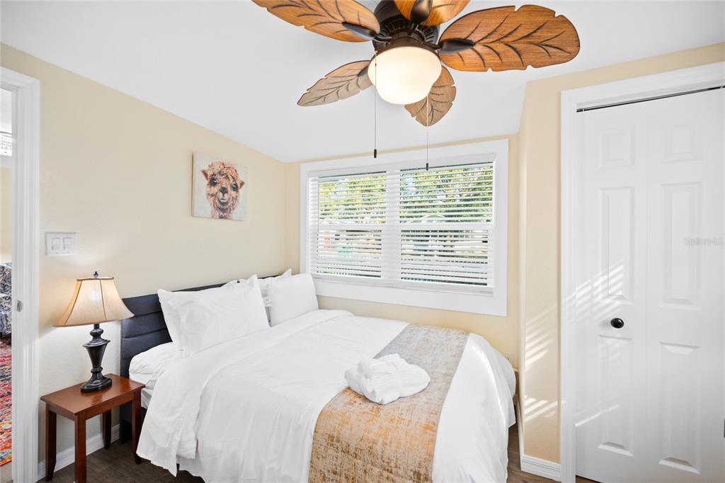 245 South Rhodes Street Mount Dora, FL 32757 - Photo 22 of 64 a bedroom with a bed and a chandelier