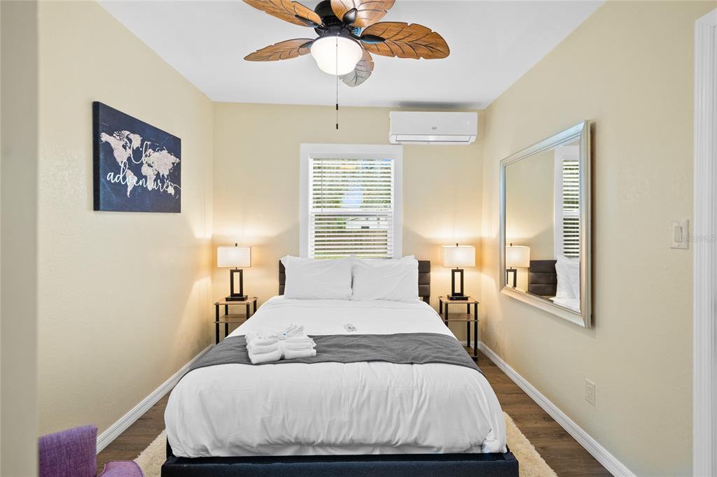 245 South Rhodes Street Mount Dora, FL 32757 - Photo 27 of 64 a bedroom with a bed and a chandelier