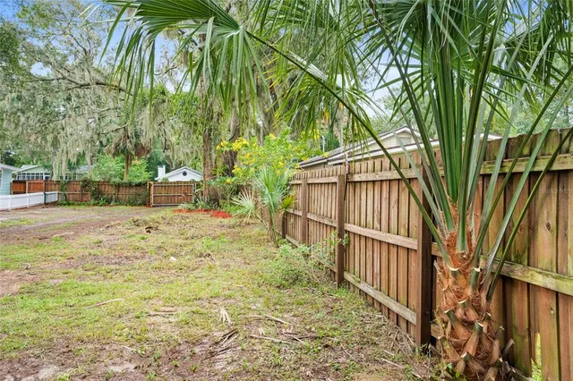 a backyard of a house with lots of green space and fountain