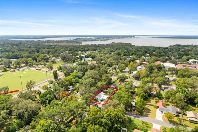 an aerial view of a house with a yard and garden