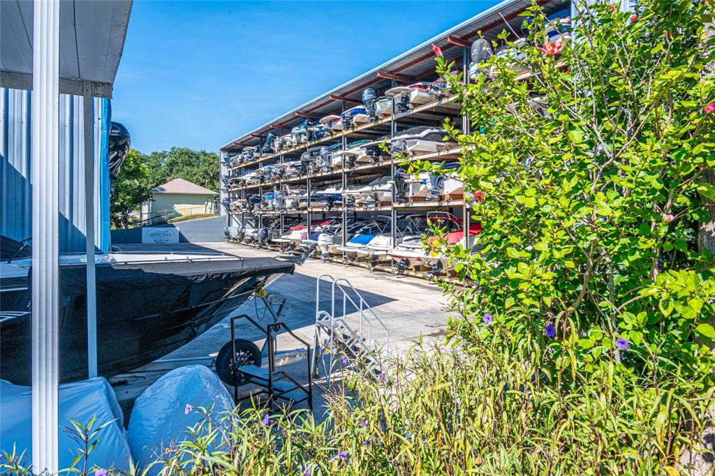 245 South Rhodes Street Mount Dora, FL 32757 - Photo 36 of 64 a roof deck with table and chairs and potted plants