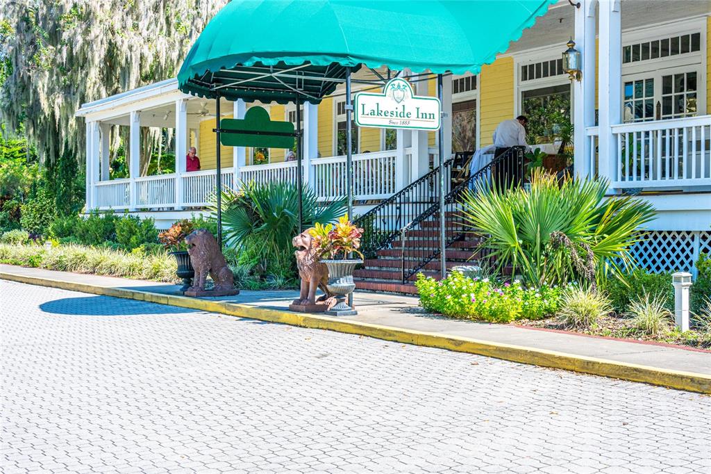 245 South Rhodes Street Mount Dora, FL 32757 - Photo 43 of 64 a front view of a house with a yard and potted plants
