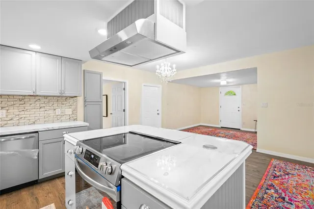 a kitchen that has a sink a stove and a table