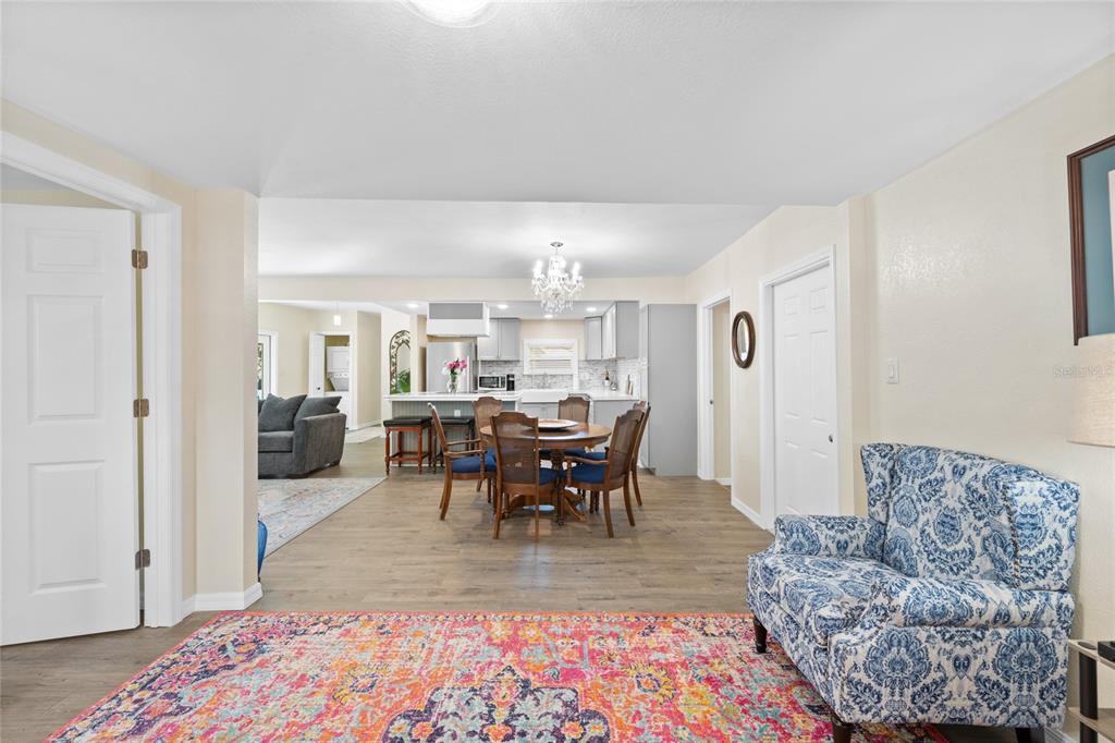 245 South Rhodes Street Mount Dora, FL 32757 - Photo 7 of 64 a living room with furniture a dining table and kitchen view
