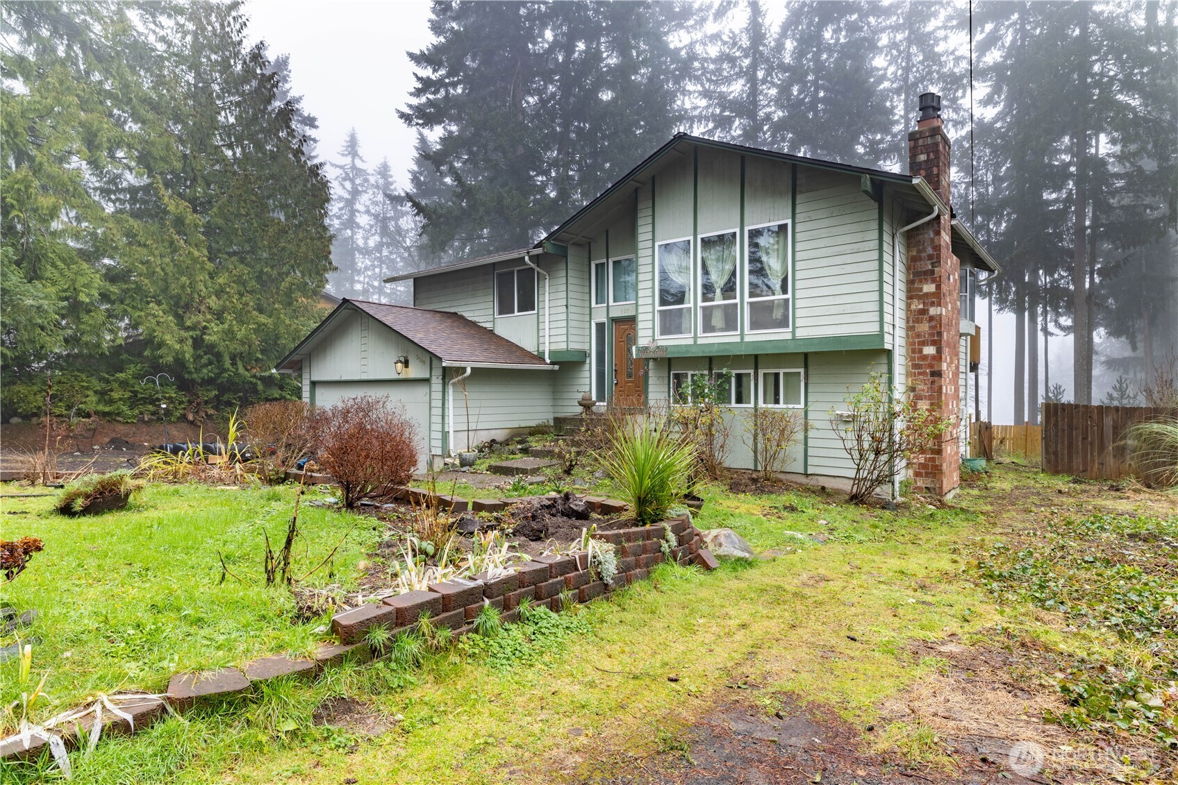 5189 Brasch Road Southeast Port Orchard, WA 98367 - Photo 2 of 24 a view of backyard of house with wooden deck and seating space