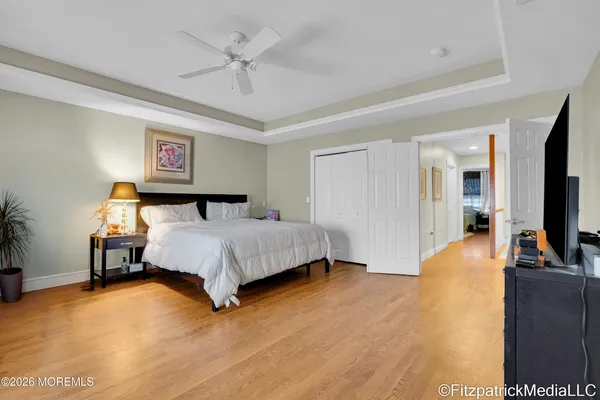 a bedroom with a bed flat screen tv and a couch