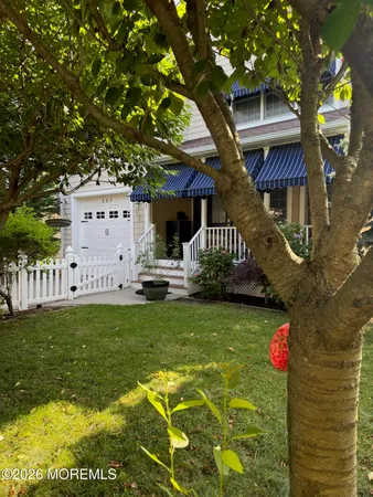 a backyard of a house with table and chairs