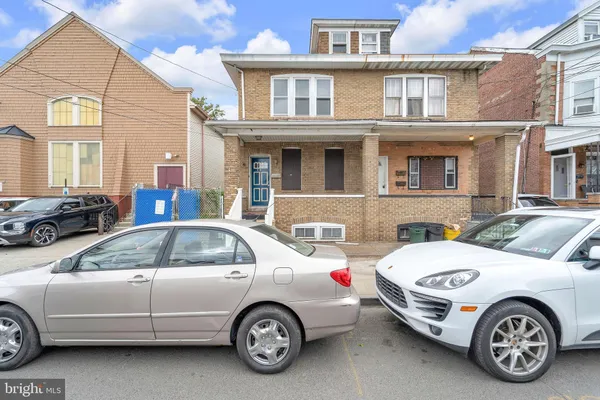 a front view of a house with parking space