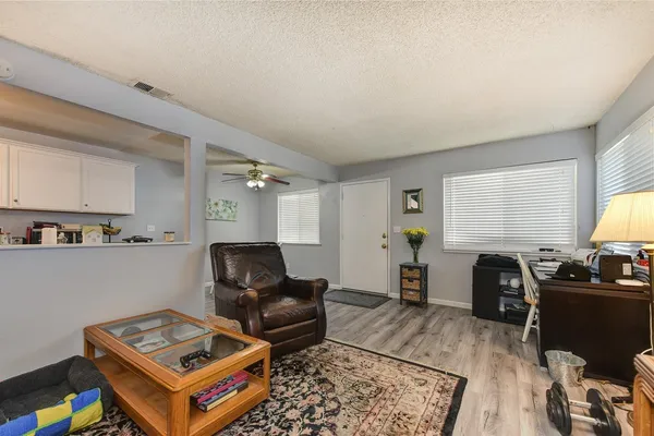 a living room with furniture a rug and a window