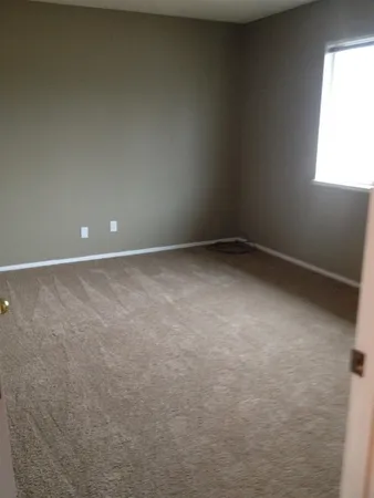 a view of an empty room and a window