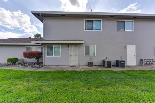 a front view of house with a garden and patio