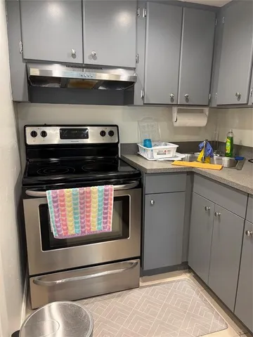 a kitchen with stove and cabinets