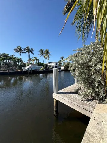 a view of a lake with chairs