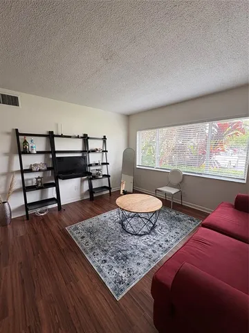 a living room with furniture and a rug