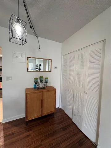a living room with wooden floor and furniture