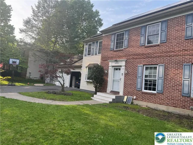a view of a house with a yard and sitting area