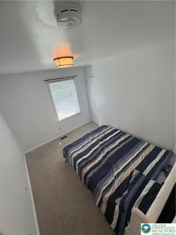 a bedroom with a bed and window