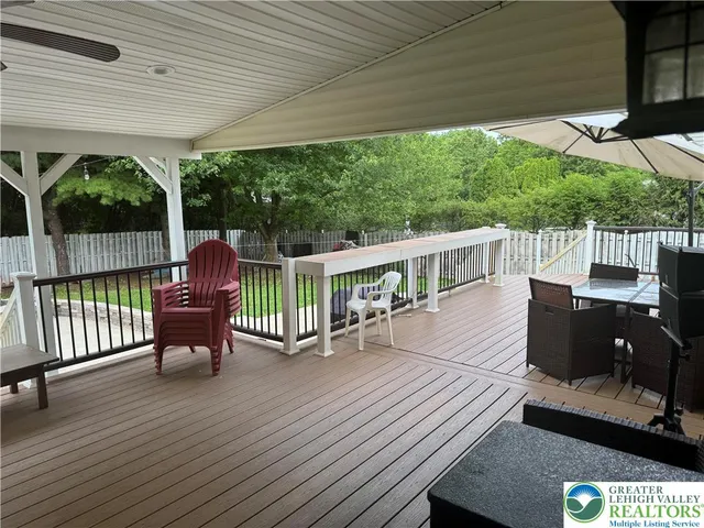 a view of a patio with a table chairs and backyard