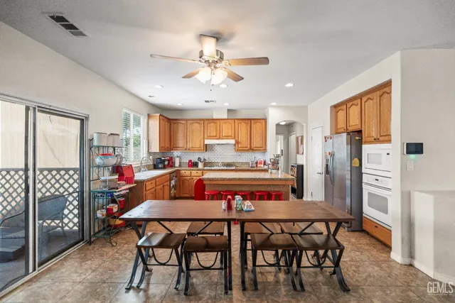 a view of a dining room with furniture and a chandelier