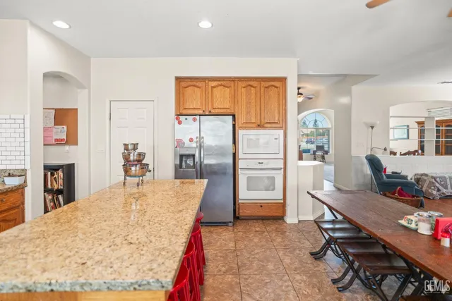 a living room with stainless steel appliances kitchen island granite countertop furniture and a kitchen view