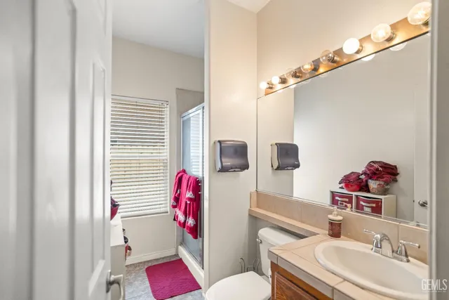 a bathroom with a sink toilet vanity and tub