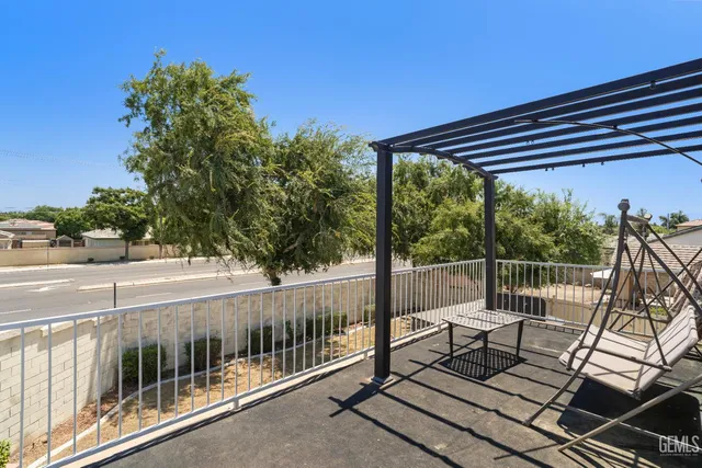 a view of a chairs and table in the balcony