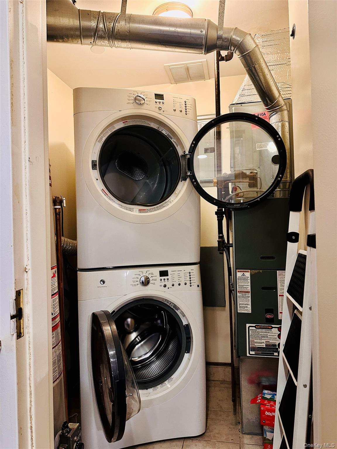 107-16 37th Avenue, Unit 4B Queens, NY 11368 - Photo 11 of 13 a utility room with dryer and washer